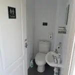 Toilet with hand basin adjacent to it